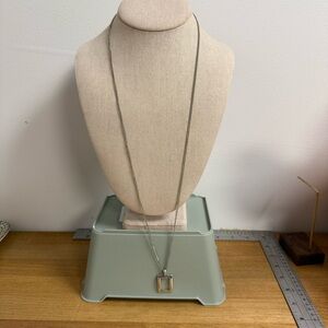 Silver tone long lanyard necklace with open square pendant